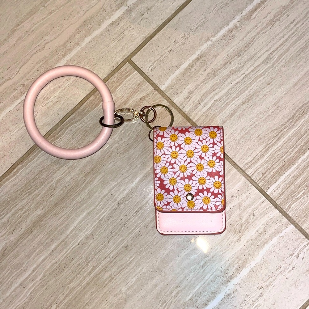 A cute pink keychain with white flowers!
